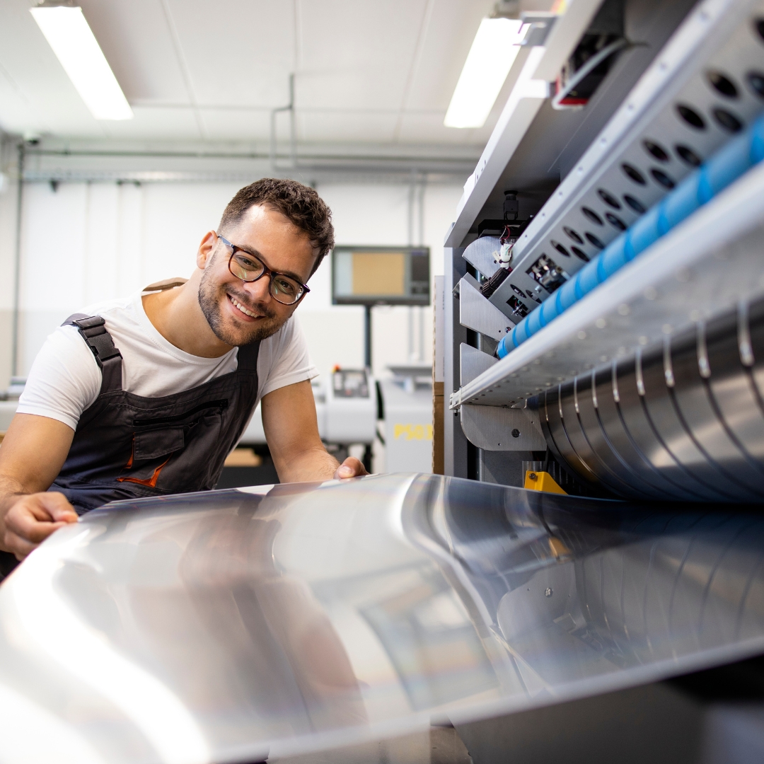 man working on a printer